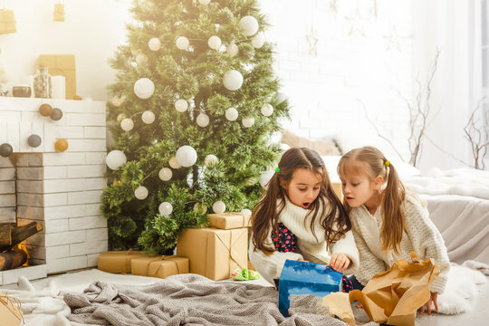 Kids Little Sisters Hold Gifts Boxes Interior Background. What A Great Surprise. Small Cute Girls Received Holiday Gifts. Best Toys And Christmas Gifts. Children Friends Excited Unpacking Their Gifts.