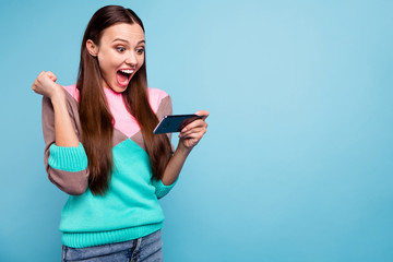 Naklejka premium Photo of positive cheerful nice glad optimistic triumphing lady using holding cellular enjoying celebrating lucky day isolated bright background