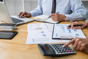 Business team are working with leader, Presentation to colleagues and business strategy and having a discussion, pointing to the graph and chart, success of cooperation partnership