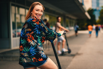Young couple on vacation having fun driving electric scooter through the city. © Zoran Zeremski
