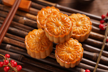 Moon cake Mooncake table setting - Round shaped Chinese traditional pastry with tea cups on wooden...