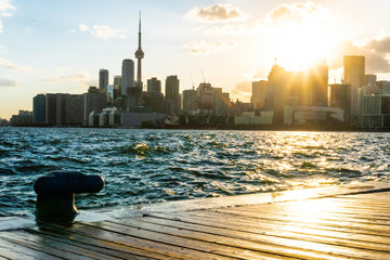 Toronto skyline at sunset with a beautiful golden reflection shot from the harbour
