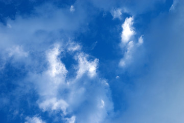 Beautiful blue sky with white clouds. Natural background of the sky with clouds.