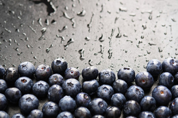 Close-up of ripe and juicy fresh picked blueberries with water drops.