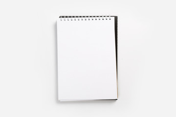 school notebook on a white background, spiral notepad on a table.