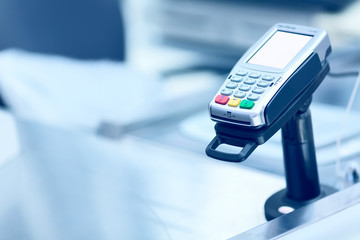 Credit card POS terminal at the checkout in a store. Retail business equipment and finance concept....