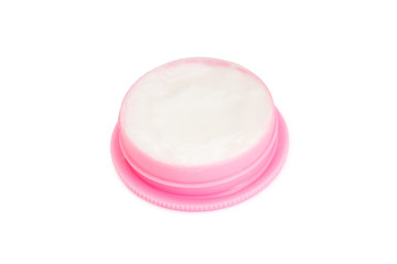 Pink plastic cream jar on white background