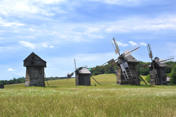 Naklejka premium Windmills. Ukraine. Ukrainian traditions. Pirogovo. Open-air museum. Blue sky. Summer. Good mood