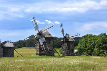Fototapeta na wymiar Windmills. Ukraine. Ukrainian traditions. Pirogovo. Open-air museum. Blue sky. Summer. Good mood