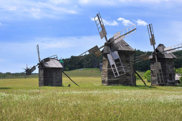 Fototapeta na wymiar Windmills. Ukraine. Ukrainian traditions. Pirogovo. Open-air museum. Blue sky. Summer. Good mood