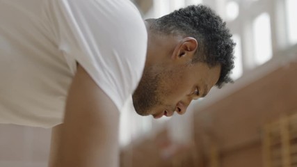 CU Portrait of young confident African American black college basketball player in checking his training results with a sports tracker device. Shot on ARRI Alexa Mini, 4K RAW graded footage - Powered by Adobe