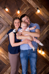 Happy Young Caucasian Family Posing in Studio