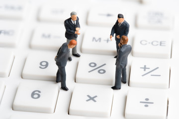 Business mans standing on calculator. Interest rate financial and mortgage rates. Compound interest rate calculation. Risk management financial and managing investment percentage interest rates.