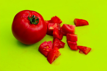 Red tomatoes on green background. Food ingredient background. Abstract food background.