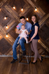 Happy Young Caucasian Family Posing in Studio