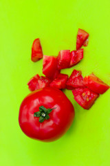 Red tomatoes on green background. Food ingredient background. Abstract food background.