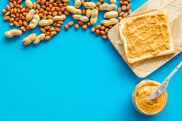 peanut butter for cooking breakfast with sandwiches at home on blue background top view mock-up