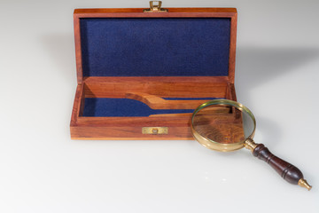 still life: office magnifying glass with wooden box