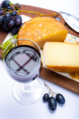 Hard Italian pecorino sheep cheese and glass with Italian red wine