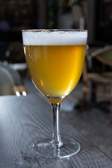 Famous Belgian beer served outside in small old cafe in special Belgian beer glass