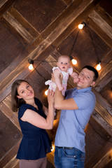 Happy Young Caucasian Family Posing in Studio