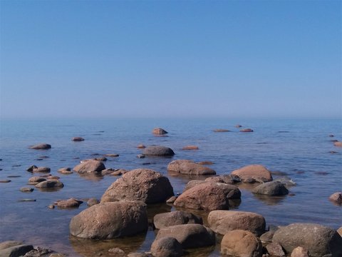 Gulf of Finland, cold northern Baltic Sea, Finland. The beauty of the northern summer. Sea, beach, large stones, horizon. Calm, peace, deserted. Introvert dream