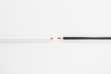 still life: office, white pencil and black pencil in white background