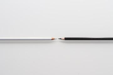 still life: office, white pencil and black pencil in white background