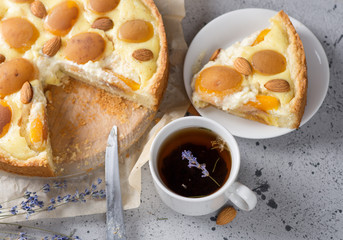 Homemade cake with almonds and apricots. A Cup of herbal tea with lavender.