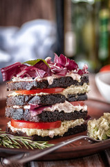 Sandwich of black bread with tomatoes