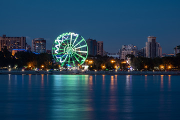 Naklejka premium Night View of the city of Khabarovsk from the Amur river. Blue night sky. The night city is brightly lit with lanterns.