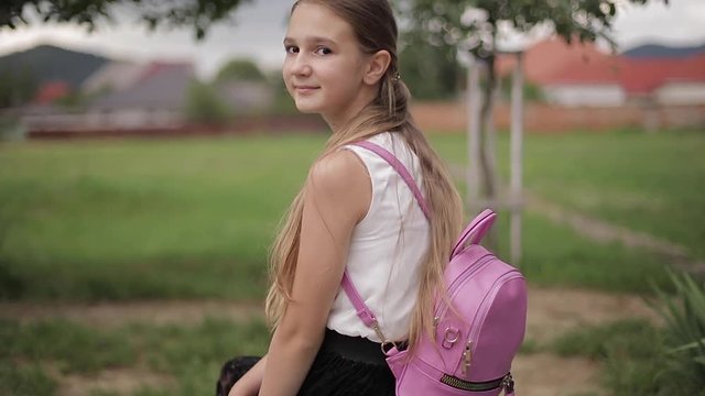 Young girl use phone during school break. Girl play online games