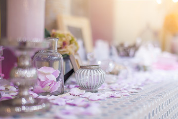 Beautiful vanity with purple flower petals and perfume bottles.dressing on teble for makeup.shallow focus effect.