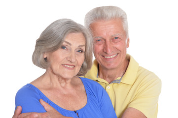 happy beautiful senior couple huging and posing on white background