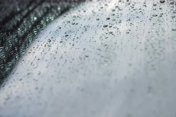 Rain drops and dew. water drops on a gray car roof after stopped raining , selective focus waterproof surface. soft focus. Leave space for writing text background.