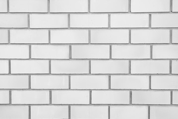 White classic brick wall close-up with stitching. The texture of the stone masonry. Brick background for a subject shooting a flat lay. Concept of construction and interior design. Copy space