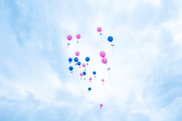 Fototapeta na wymiar colorful balloons fly into the sky. on ribbons attached paper doves.