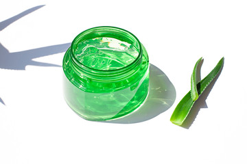 Aloe vera fresh gel in a plastic bottle close up on the white background. After sun cooling skin cosmetics