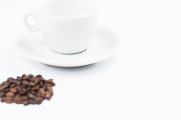 Coffee beans and cup isolated on white background.Copy space