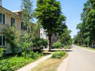 Fototapeta na wymiar municipal houses with green front gardens on Kuban