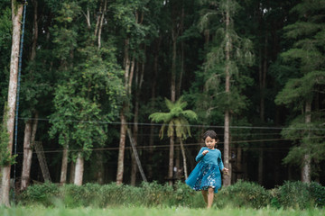 little daughter having fun alone while enjoying playing in the park