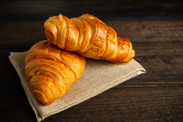 croissants on old wooden table.