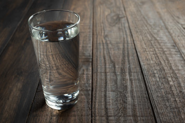 Glasses of water on a wooden table.