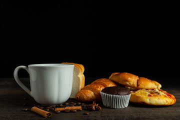cup of coffee bread on wooden table.