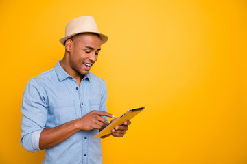 Proifile side photo of focused cheerful youth use user device check voyage isolated over yellow...