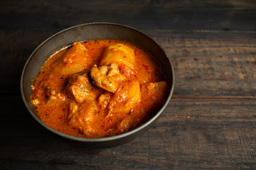 Goulash soup on wooden background.