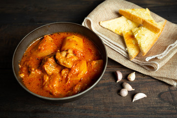 Goulash soup on wooden background.