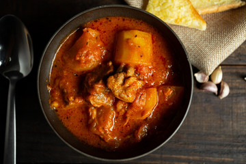 Goulash soup on wooden background.