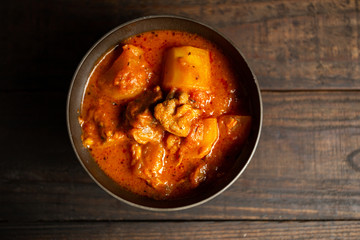 Goulash soup on wooden background.