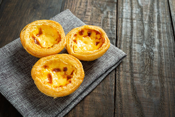 Egg tart on wooden background.